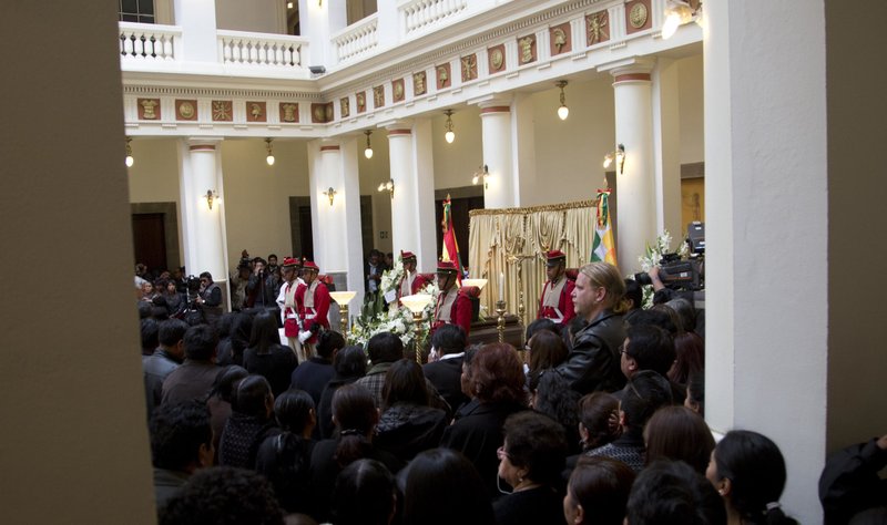 Mourners gather before the coffin containing the remains of Bolivia's Deputy Minister of Internal Affairs Rodolfo Illanes, during a Mass inside the government palace in La Paz, Bolivia Friday, Aug. 26, 2016.