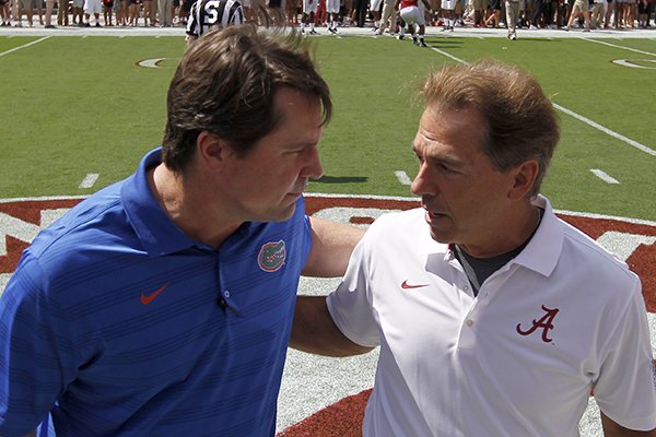 Florida head coach Will Muschamp, left, talks with Alabama coach Nick Saban before an NCAA college football game against on Saturday, Sept. 20, 2014, in Tuscaloosa, Ala. (AP Photo/Butch Dill)