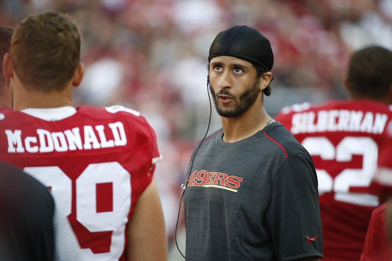 San Francisco 49ers quarterback Colin Kaepernick stands on the sidelines during the second half of an NFL preseason football game against the Houston Texans Sunday in Santa Clara, Calif.