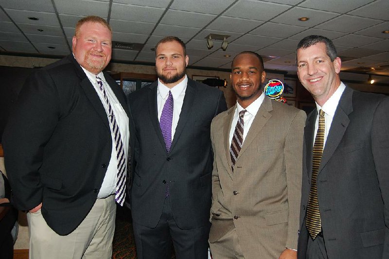 Arkansas Democrat-Gazette/HELAINE R. WILLIAMS

Brett Shockley, Offensive line/ tight ends coach at Ouachita Baptist University in Arkadelphia, Ouachita Baptist left tackle Mike Russell;  Trevon Biglow, defensive lineman, Harding University in Searcy; and Harding assistant Coach Paul Simmons at the Little Rock Touchdown Club's 12th annual Awards Banquet featuring Darren McFadden, held Feb. 11 in the  ballroom of the Embassy Suites Little Rock.