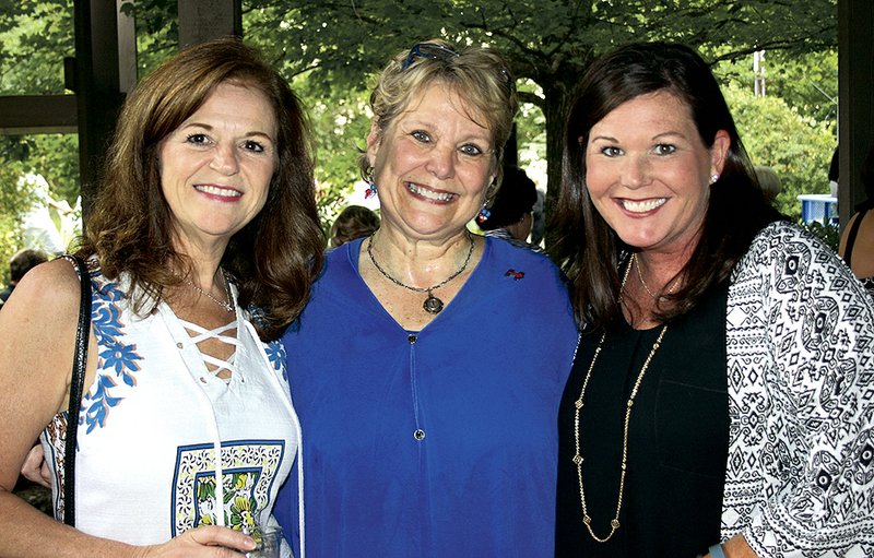 Barb Putman (from left), Denise Garner and Jennifer Irwin visit at the TheatreSquared season kickoff Aug. 16 at the Garners’ home in Fayetteville.