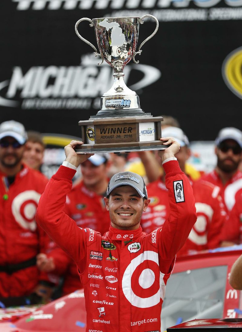 Kyle Larson celebrates after winning the NASCAR Sprint Cup Series auto race at Michigan International Speedway in Brooklyn, Mich., Sunday, Aug. 28, 2016. 