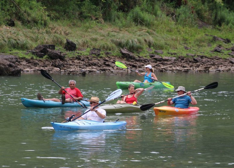 With Steve Joseph up front and Valarie Keown at back, Ali Moubarak (from left), Kristin Jones and Russ Stinebaugh enjoy The NWA Hiking Meetup Group’s relaxed outing Aug. 13 on the White River below Beaver Dam.