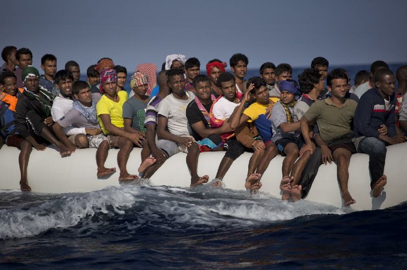 Migrants and refugees fleeing Libya on board a dinghy in the Mediterranean Sea north of Sabratha, Libya, sail toward Italy on Sunday.