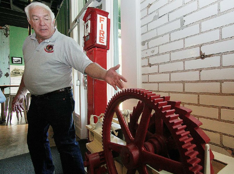 Museum Curator Johnny Reep talks Wednesday about some of the equipment at the newly opened Firehouse Hostel in Little Rock.