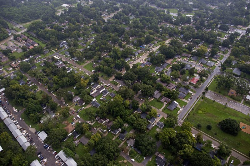 In this Aug. 25, 2016 photo, debris from gutted homes line the streets of Baton Rouge, La. 