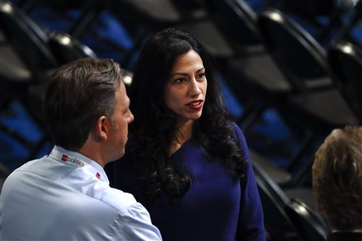 Huma Abedin, right, an aide to Democratic presidential candidate Hillary Clinton, talks on the floor of the Democratic National Convention in Philadelphia on Tuesday, July 26, 2016.