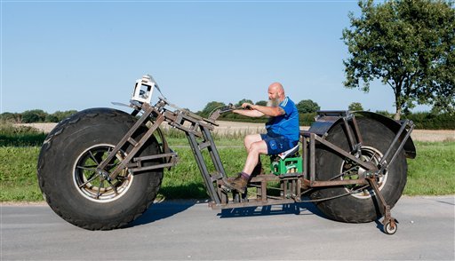 In this photo taken Saturday, Aug. 27, 2016, Frank Dose for the first time rides his self made bicycle in Rade, Germany. 

