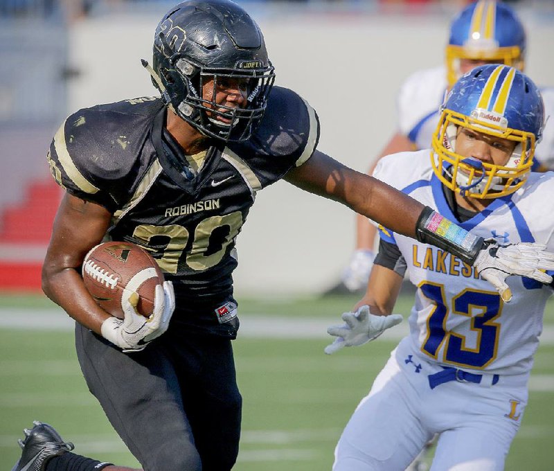 Joe T. Robinson’s Edmond Robinson scores his team’s third touchdown in the Senators’ 51-28 victory over Hot Springs Lakeside on Monday night at War Memorial Stadium in Little Rock.