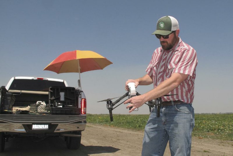 Danny Royer prepares to pilot a drone over a tomato fi eld last month near Los Banos, Calif., to search for leaks in a farm’s irrigation system. Thousands of would-be drone operators are expected to take a federal licensing exam for commercial operation.