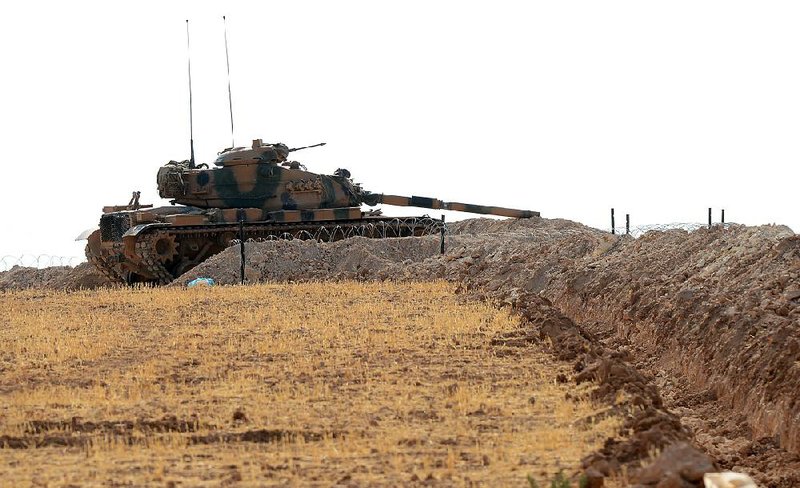 A Turkish tank is positioned Monday near the Syrian border in Karkamis, Turkey.
