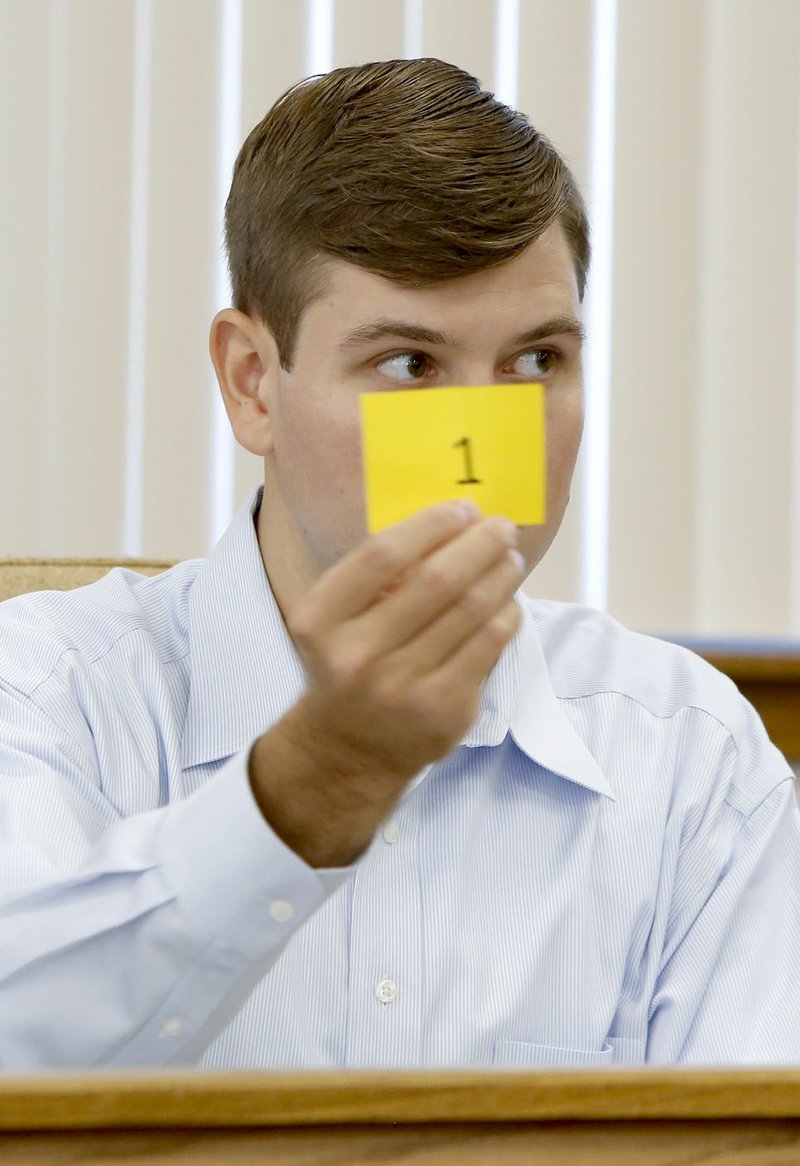 Max Deitchler, Washington County election commissioner, displays a ballot position Monday for the Nov. 8 general election in front of the Election Committee at the Washington County Courthouse in Fayetteville. Ballot positions were chosen for 28 races for the election.