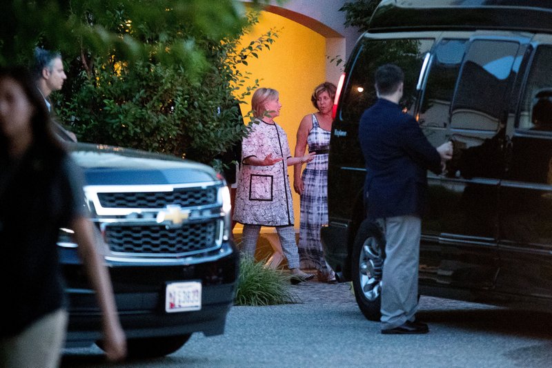 Democratic presidential candidate Hillary Clinton, center left, leaves the home of Marcia Riklis, center right, following a private fundraiser in Southampton, N.Y., Sunday, Aug. 28, 2016.