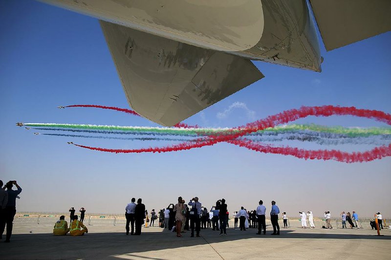 Visitors watch the United Arab Emirates’ Al Fursan aerobatic team perform at the 14th Dubai Air Show in Dubai, United Arab Emirates, in this file photo. U.S. airlines complained last year to the General Services Administration after it chose JetBlue and its partner airline, Emirates, to fly government employees on a New York to Dubai route. 
