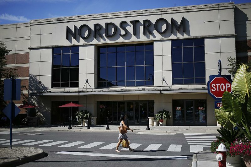A pedestrian passes a Nordstrom Inc. store at the Easton Town Center shopping mall last week in Columbus, Ohio. Consumer confidence rose in August to its highest level in 11 months, the Conference Board said Tuesday. 