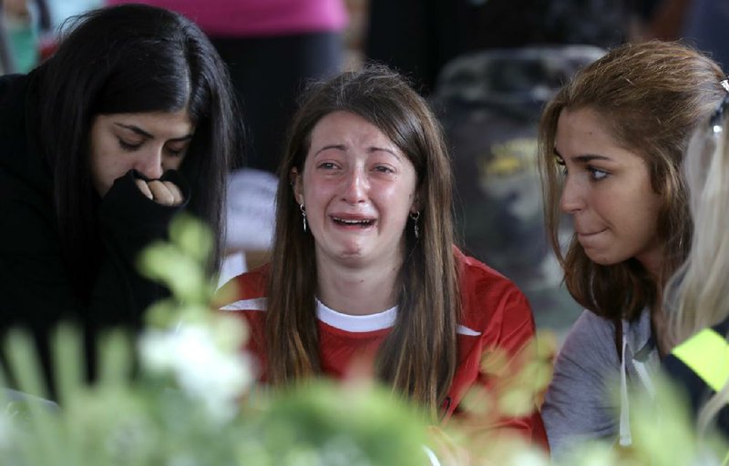 A woman cries Tuesday before a state funeral for some of the victims of last week’s earthquake in Amatrice, Italy.