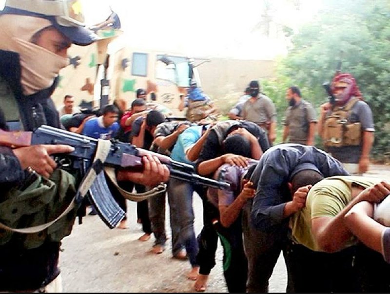 This image posted online by Islamic State militants in June 2014 shows captured Iraqi cadets moments before they were executed in Tikrit in northern Iraq. Their bodies are believed to be among those in many mass graves left by Islamic State fighters across Iraq and Syria. 