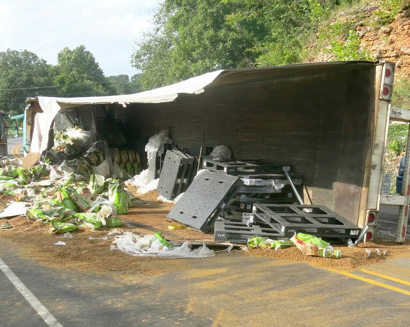 Photo by Susan Holland A collision between two tractor-trailer rigs on Arkansas Highway 59 Tuesday afternoon, Aug. 23, 2016, closed the higway for hours while a spilled load of dog food was cleaned up and the overturned trucks were removed.