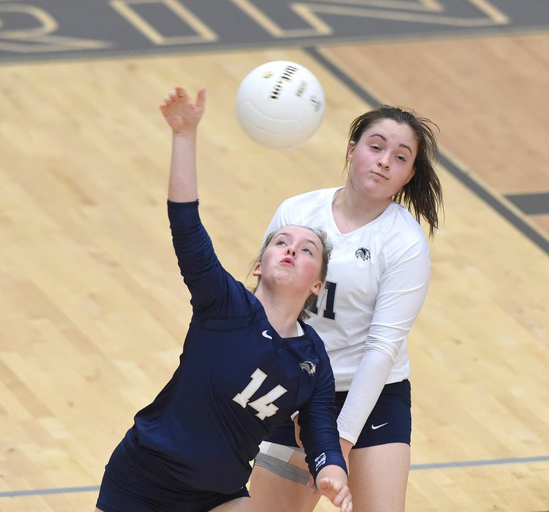 Saea O'Brien (14) and Lauren Hawks (11) of Bentonville West High School move into position to play the ball Tuesday against Webb City at Bentonville West High School.