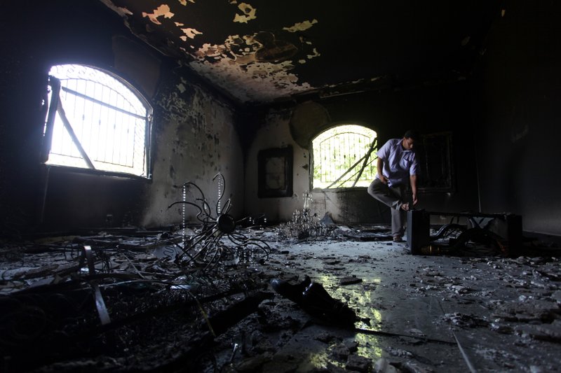  In this Sept. 13, 2012 file photo, a Libyan man investigates the inside of the U.S. consulate in Benghazi, Libya, after a deadly attack two days earlier. 