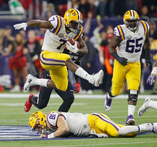 In this Dec. 29, 2015, file photo, LSU running back Leonard Fournette (7) hurdles tight end Colin Jeter (81) as he rushes against Texas Tech during the first half of the Texas Bowl  in Houston. All eyes are on Fournette as fifth-ranked LSU enters Week 1 of a highly anticipated season. 