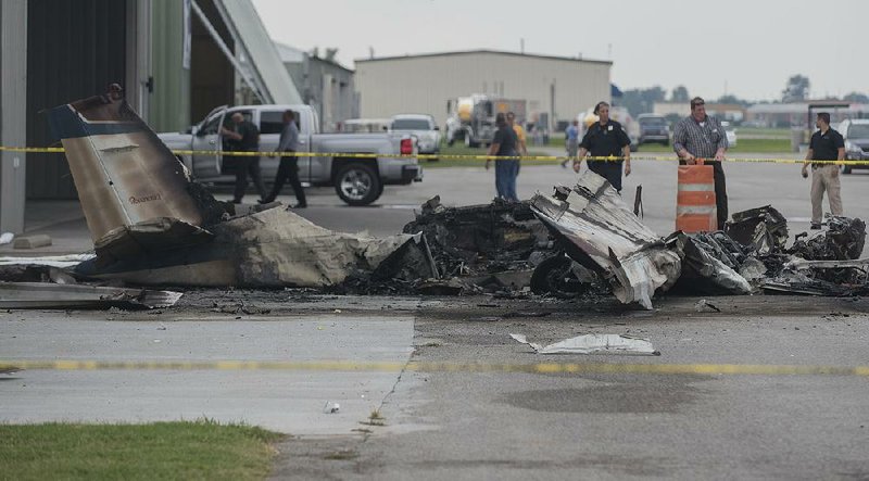 Emergency workers gather at the site of a plane crash Wednesday at Bentonville Municipal Airport. 