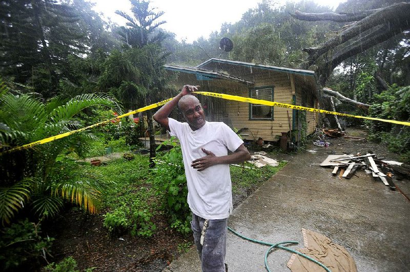 Andre Anton is blocked from gathering belongings from his home Wednesday in Tampa, Fla., after a tree knocked over by Tropical Storm Hermine fell on the house. A state of emergency has been declared for 42 counties in Florida as Hermine gains strength. Off Hawaii, Hurricane Madeline weakened into a tropical storm as it veered away from the islands. 