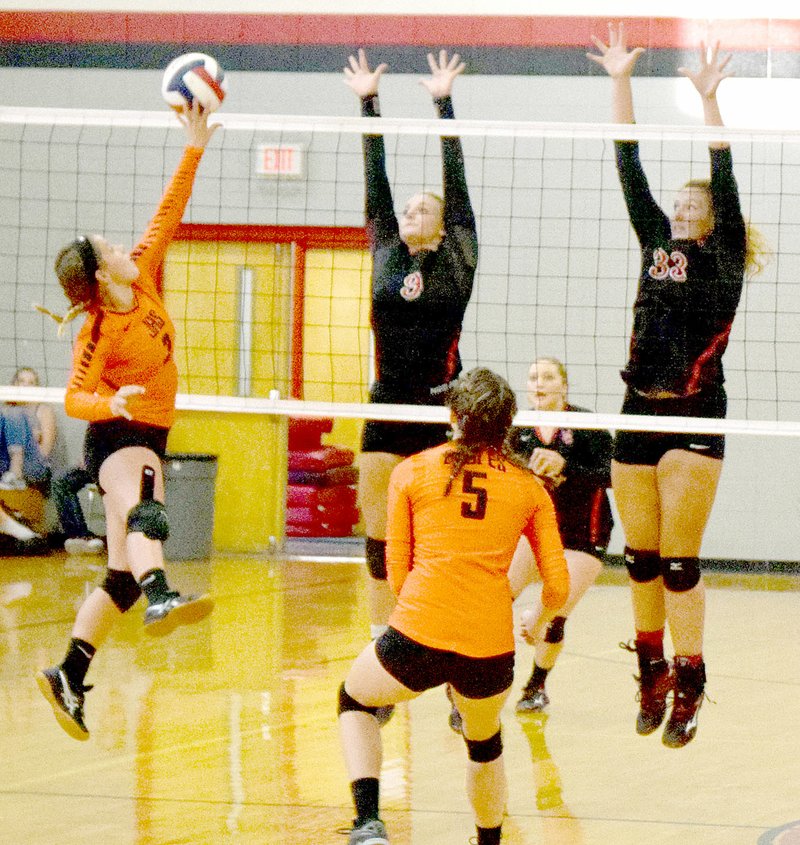 Photo by Rick Peck McDonald County&#8217;s Alex Gross (9) and Lindsey Limore (33) try to block a spike block during the Lady Mustangs&#8217; 25-3, 25-10 to open the 2016 high school volleyball season on Aug. 23 at MCHS.
