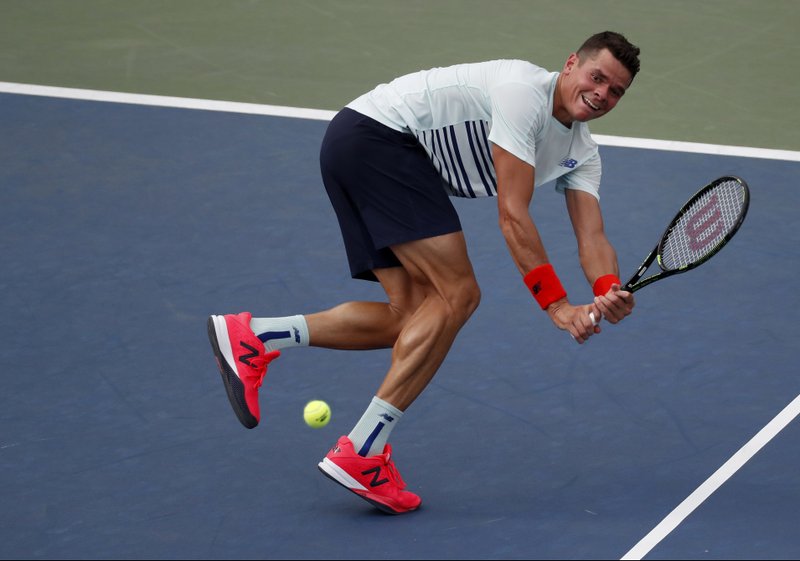 Milos Raonic, of Canada, returns a shot to Ryan Harrison, of the United States, during the second round of the U.S. Open tennis tournament, Wednesday, Aug. 31, 2016, in New York. 