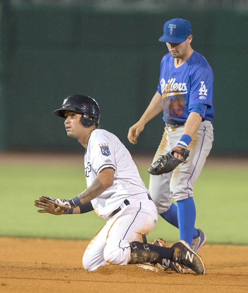 Humberto Arteaga (2) of the Northwest Arkansas Naturals calls for time Wednesday after sliding into second base against the Tulsa Drillers at Arvest Ballpark in Springdale. The Naturals battled the Drillers with a share of first-place on the line for Northwest Arkansas.