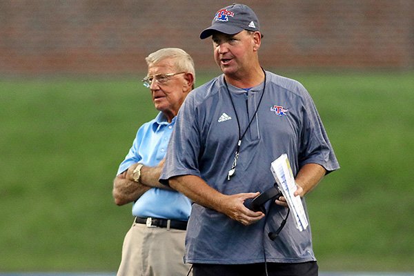 Former Razorbacks coach Lou Holtz visited the Louisiana Tech football practice Aug. 20, 2016, in Ruston, La. The Bulldogs are coached by Skip Holtz (right), Lou's son.