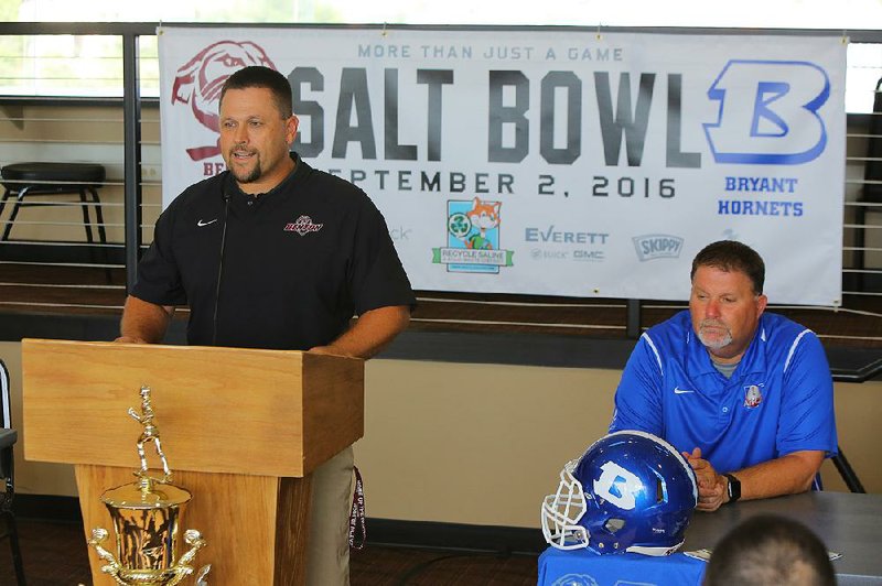 Benton Coach Brad Harris (left) addresses members of the media while Bryant Coach Buck James looks on during a Salt Bowl news conference Monday. A large crowd is expected tonight when the Saline County rivals meet for the 44th time. Bryant has won nine of the past 10 meetings, including a 37-13 decision last season.