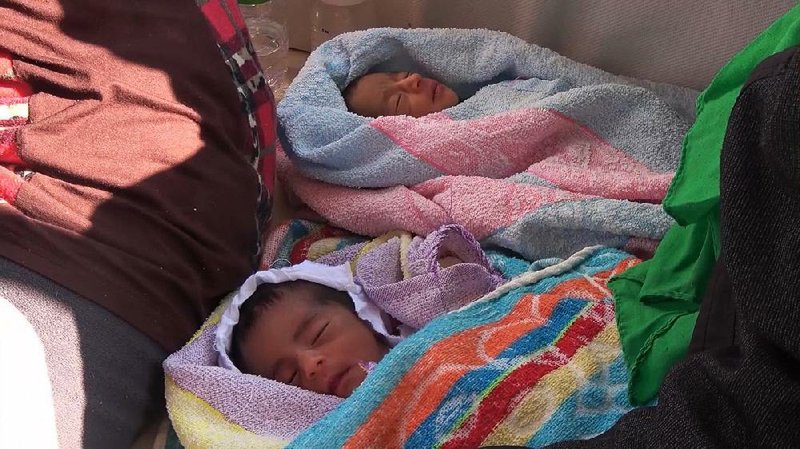 Eritrean twins, who were born in Libya, are rescued earlier this week from the Mediterranean Sea by two humanitarians groups aided by the Italian navy. 