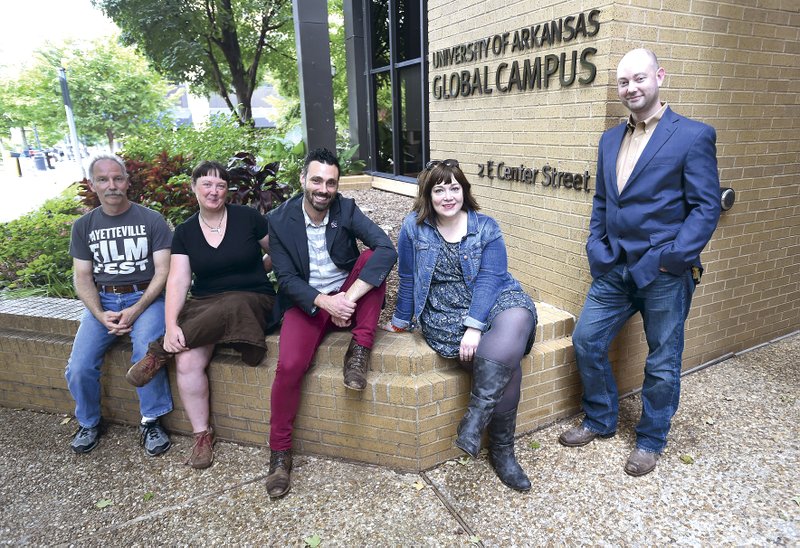 Gary Berger, chief juror, from left, pauses with Hanna Withers, board member, Jason Suel, board member, Morgan Hicks, board member, and Dan Robinson, executive director of the Fayetteville Film Festival, outside the University of Arkansas Global Campus on the Fayetteville square. The Fayetteville Film Festival starts Tuesday.