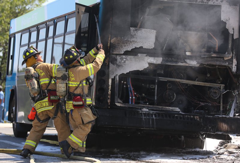 Little Rock firefighters extinguish a fire on a Rock Region Metro bus Friday afternoon on Midtown Avenue. No injuries were reported.