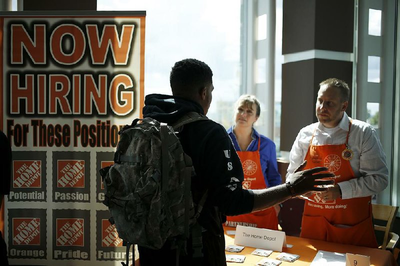 A job seeker speaks with recruiters from The Home Depot at an employment event for military veterans Thursday in Cleveland.
