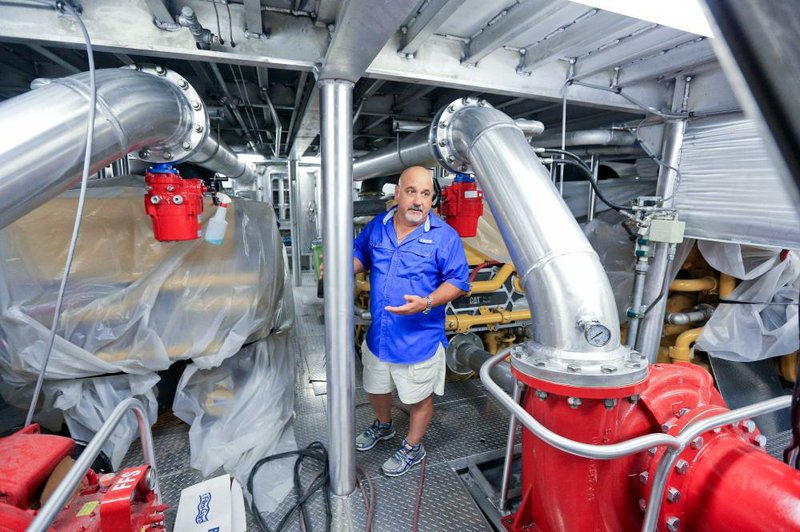 Vance “Vic” Breaux Jr., president at Breaux Brothers Enterprises Inc., stands in the engine room of a supply boat in Loreauville, La., last month. The company is fi nishing it’s last two boats with no other orders on the horizon.