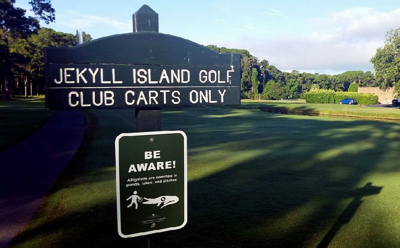 A sign warns golfers to “Be Aware” of alligators on Jekyll Island, Ga. The state park recently placed roughly 30 signs at golf course entrances, ponds and ditches to make sure visitors know the island is home to an abundance of alligators. 