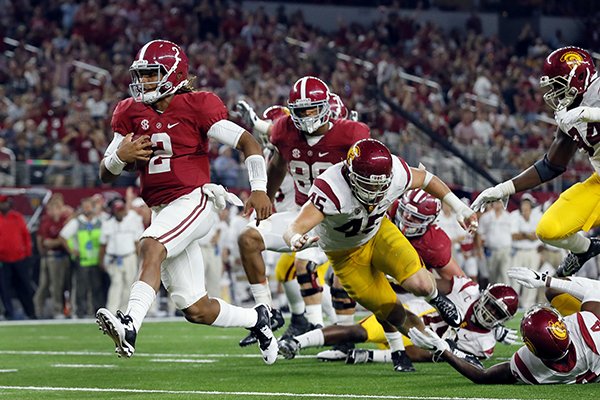 Alabama quarterback Jalen Hurts slips into the end zone on a 7-yard touchdown run during the second half of an NCAA college football game against Southern California on Saturday, Sept. 3, 2016, in Arlington, Texas. (AP Photo/Tony Gutierrez)

