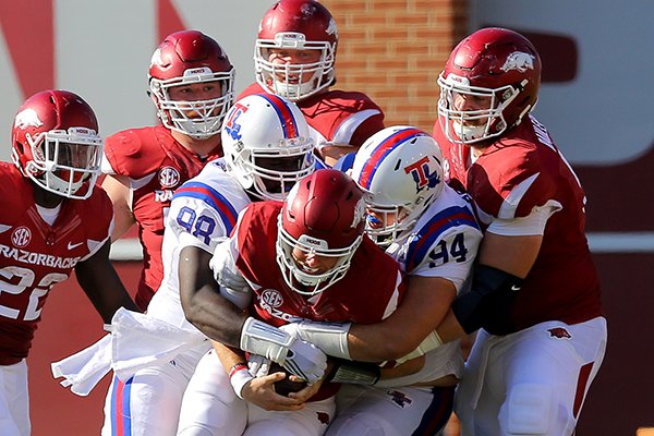 Arkansas' Austin Allen is sacked by Louisiana Tech's defenders in the third quarter of a game Saturday Sept. 3, 2016 in Fayetteville. 