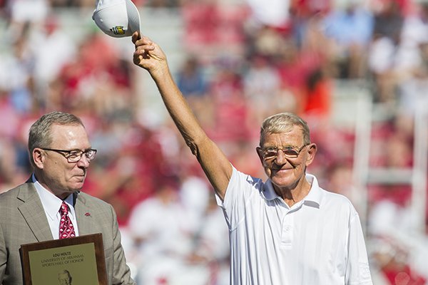Former Arkansas coach Lou Holtz acknowledges the crowd at halftime of a game against Louisiana Tech on Saturday, Sept. 3, 2016, in Fayetteville. 