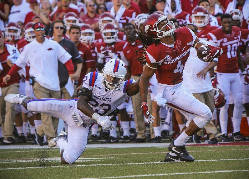 9/3/16
Arkansas Democrat-Gazette/STEPHEN B. THORNTON
Arkansas' Keon Hatcher shakes a tackle by  Louisiana Tech's Prince Sam, left, to move the ball to the 7 yard line and set up the Hog winning TD during the third quarter of their game Saturday Sept. 3, 2016 in Fayetteville, Ark.

