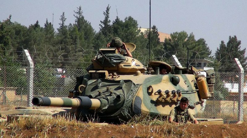 Turkish soldiers are stationed Saturday in Suruc, near the country’s border with Syria. 