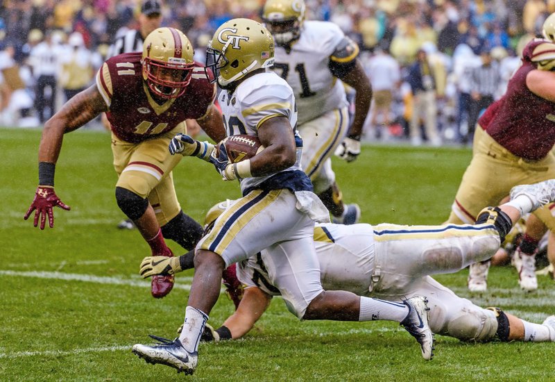 In this photo released by Georgia Tech, Georgia Tech's Dedrick Mills (26) evades Boston College defensive end Wyatt Ray (11) during the first half of an NCAA college football game, Saturday, Sept. 3, 2016, in Dublin, Ireland. Georgia Tech won 17-14. 