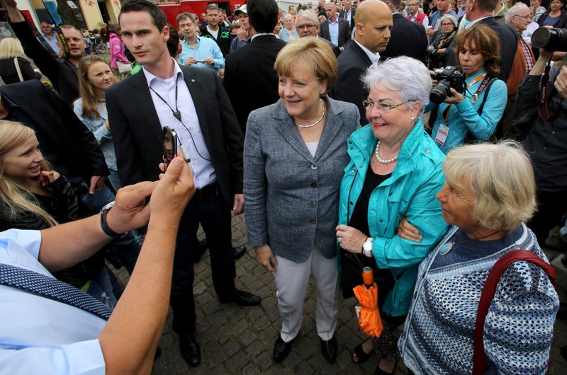 German Chancellor Angela Merkel , center, poses with supporters during an election campaign event in Bad Doberan, eastern Germany, Saturday Sept. 3, 3016.