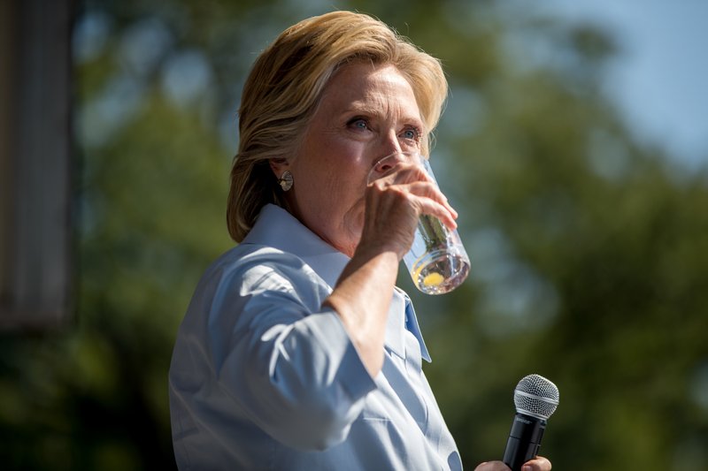 Democratic presidential candidate Hillary Clinton pauses to drink water after coughing as she speaks at the 11th Congressional District Labor Day festival at Luke Easter Park in Cleveland, Ohio, Monday, Sept. 5, 2016. 