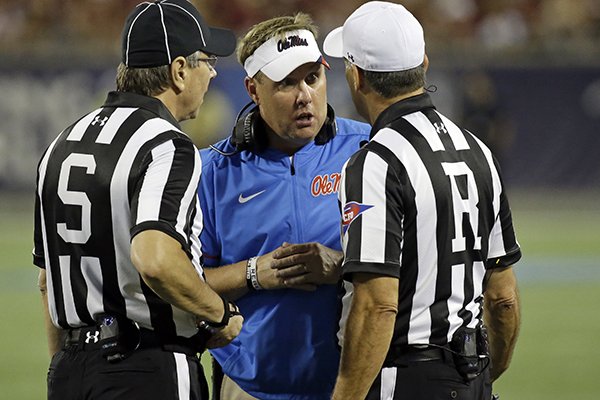 Mississippi head coach Hugh Freeze, center, has words with officials during the first half of an NCAA college football game against Florida State, Monday, Sept. 5, 2016, in Orlando, Fla. (AP Photo/John Raoux)

