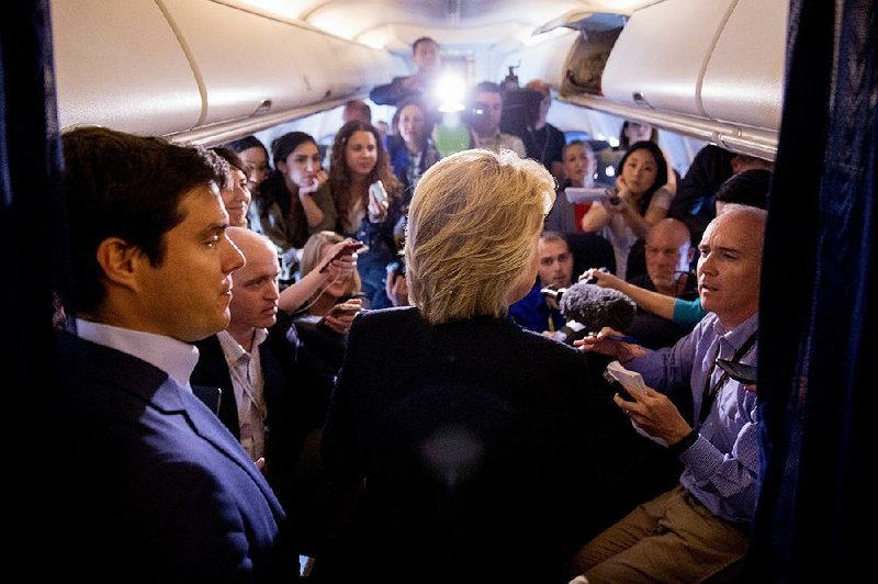 Hillary Clinton talks with reporters Tuesday on her campaign plane en route to Tampa, Fla.  