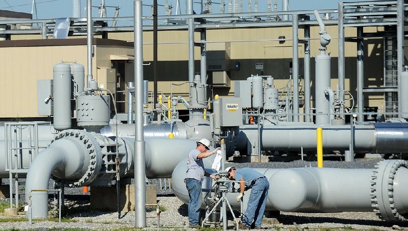 Workers make repairs to the pipeline hub run by Spectra Energy Corp. in Guilford, Pa., in this file photo. Canada’s Enbridge is buying Houston-based Spectra Energy for about $28 billion, creating North America’s largest energy infrastructure company, the companies announced Tuesday. 