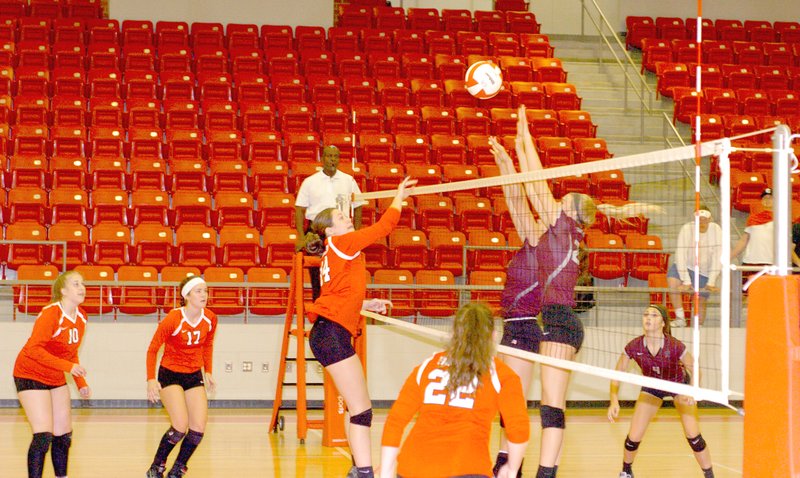 MARK HUMPHREY ENTERPRISE-LEADER Farmington middle hitter Ella Wilson has her hit contested by Madison Cooper and Shaylon Sharp of Siloam Springs. The Lady Panthers defeated Farmington (22-25,22-25,25-22,25-18,19-17) Aug. 30.